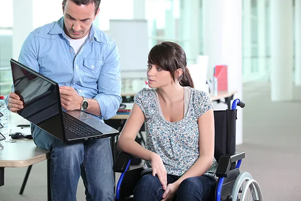 A woman in a wheelchair reviews Short Term Disability Insurance options in Vero Beach, FL